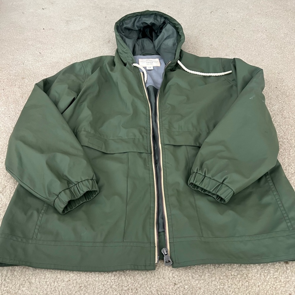 Green rain jacket. Size lg zipper with two kinds of pockets that stay dry.